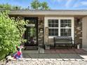 Inviting front porch with seating, decorative elements, and a view of the home's address at 1039 Eastlawn Dr, Whiteland, IN 46184