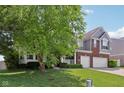 Attractive two-story home with brick and siding, featuring a covered porch and well-maintained landscaping at 10716 Patoka Rd, Indianapolis, IN 46239