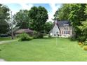 Charming two-story home with lush green lawn and traditional architecture at 115 Northshore Blvd, Anderson, IN 46011