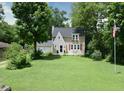 Beautiful two-story home with a large front lawn and mature trees at 115 Northshore Blvd, Anderson, IN 46011