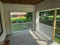 View from the covered porch of a lovely green lawn and tree lined neighborhood at 118 S Swain St, Ingalls, IN 46048
