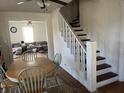 Dining room with table and chairs, open to the living room and staircase at 118 S Swain St, Ingalls, IN 46048