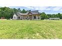 Charming two-story home with a covered porch, spacious yard, and beautiful stone and brick accents at 1284 N Letterman Rd, Paragon, IN 46166