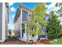 Charming two-story home with blue siding, white trim, a welcoming porch, and beautifully landscaped front yard at 12874 Tradd St, Carmel, IN 46032