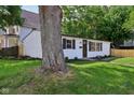 A lovely home accented by a mature shade tree enhancing curb appeal and a cozy feel at 1648 Ringgold Ave, Indianapolis, IN 46203