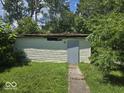Exterior of a weathered detached garage in disrepair with peeling paint and damaged roof at 1816 E Highland Ave, Muncie, IN 47303