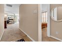 Inviting hallway featuring neutral walls and carpeting, with views into the living spaces and bedrooms at 1912 Blue Pine Ln, Indianapolis, IN 46231