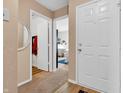 Hallway featuring neutral walls and carpeting, and white doors leading to other rooms in the home at 1912 Blue Pine Ln, Indianapolis, IN 46231