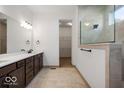 Stylish bathroom featuring a double vanity, large mirror, and a glass-enclosed tiled shower at 19995 Gansett Rd, Westfield, IN 46074
