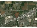 Aerial view of property outlined in red showing home and surrounding land with road and neighborhood at 2000 Hawthorne Dr, Plainfield, IN 46168