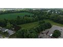 Aerial view of tree lined property showing some buildings and mature landscaping at 2000 Hawthorne Dr, Plainfield, IN 46168