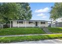 Charming single-story home with a welcoming front porch and well-maintained lawn at 212 N 13Th St, Elwood, IN 46036