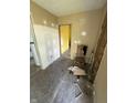 Living room undergoing renovations with exposed walls, and a vintage wooden chair at 2215 Noble St, Anderson, IN 46016