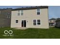View of the home's rear facade showing access to the backyard and green space at 2230 Cedarmill Dr, Franklin, IN 46131