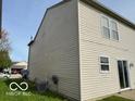 Side view of the house highlighting the siding and access to outdoor utilities at 2230 Cedarmill Dr, Franklin, IN 46131