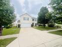 Well-kept home with a two-car garage, long driveway and a neatly landscaped front yard at 2292 Hampton Dr, Franklin, IN 46131
