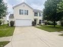 Traditional home with a spacious driveway, two-car garage, and a lush green lawn at 2292 Hampton Dr, Franklin, IN 46131