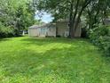 View of the home from the backyard showing the sliding glass door and a spacious yard at 2626 Fairhaven Dr, Indianapolis, IN 46229