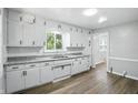 Bright kitchen with white cabinets, a stainless steel sink, and modern countertops at 3609 N Keystone Ave, Indianapolis, IN 46218