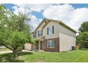 Two-story home with brick and siding, complemented by a lush front yard and mature trees at 373 Austin Dr, Avon, IN 46123
