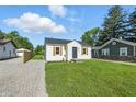 Charming house featuring new lawn and gravel driveway at 452 N Fenton Ave, Indianapolis, IN 46219
