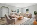 Inviting living room featuring ample seating, a large area rug, and abundant natural light at 452 N Fenton Ave, Indianapolis, IN 46219