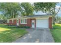 Well-maintained brick home with an attached one-car garage and a verdant front lawn at 4625 Beth Ann Dr, Indianapolis, IN 46221