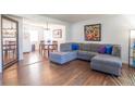 Inviting living room with hardwood floors, a comfortable gray sectional, and open dining area at 4625 Beth Ann Dr, Indianapolis, IN 46221