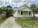 Charming home with a gravel driveway, covered front porch, and well-maintained lawn at 492 S Livingston Ave, Indianapolis, IN 46241