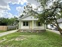 Charming home with a covered front porch, attractive green trim, and well-kept lawn at 492 S Livingston Ave, Indianapolis, IN 46241