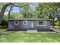 This well-kept single-story home features a charming gray exterior at 5407 Adelaide St, Indianapolis, IN 46203