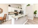 Bright kitchen features granite countertops, stainless steel appliances, and a breakfast bar with seating at 5765 White Pine Rd, Whitestown, IN 46075