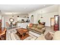 Spacious open-concept living room featuring wood floors, neutral paint, and combined seating and kitchen area at 5765 White Pine Rd, Whitestown, IN 46075