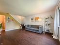 A bright living room showcases hardwood floors, comfortable sofa, and modern decor elements at 5965 Deerwood Ct, Indianapolis, IN 46254