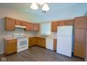 Well-lit kitchen featuring wooden cabinets and appliances at 6029 Sycamore Forge Dr, Indianapolis, IN 46254