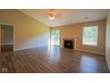 Spacious living room featuring a fireplace, new flooring, and sliding glass doors to the back yard at 6029 Sycamore Forge Dr, Indianapolis, IN 46254