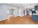 Open-concept living room with wood floors and neutral paint; flows to kitchen at 615 Udell St, Indianapolis, IN 46208