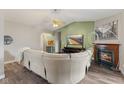 Spacious living room with wood flooring, a fireplace, and comfortable seating, ideal for relaxation at 619 Cahill Ln, Indianapolis, IN 46214