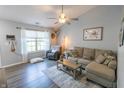 Bright living room featuring hardwood floors, a large window, and comfortable seating at 740 Springmill Dr, Mooresville, IN 46158