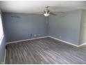 Bright living room with new grey wood-look flooring and a ceiling fan at 9138 E 18Th St, Indianapolis, IN 46229