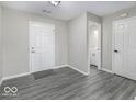 Bright entryway with durable floors, neutral walls, and convenient access to a half-bath at 9665 Gull Lake Dr, Indianapolis, IN 46239