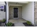 Inviting entrance featuring a brick facade, white siding, and a dark-colored front door at 9665 Gull Lake Dr, Indianapolis, IN 46239