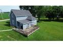 Spacious backyard with a wooden deck, ideal for outdoor entertaining and relaxation at 9721 S 100 E, Pendleton, IN 46064