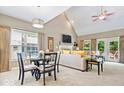 Bright living room with vaulted ceilings, a fireplace, and a dining area, perfect for entertaining guests at 10381 Beaver Ridge Dr, Fishers, IN 46037