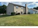 Spacious backyard featuring a well-maintained lawn and a patio area for outdoor seating at 11154 Schoolhouse Rd, Fishers, IN 46037