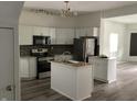 Modern kitchen with stainless steel appliances, center island, and sleek white cabinetry at 1125 N Rural St, Indianapolis, IN 46201