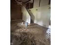 Empty living room with stairs, panelling, and dated flooring at 1330 Schleicher Ave, Indianapolis, IN 46229