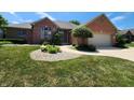 Attractive brick home with meticulous landscaping, including stone mulch and flowering shrubs at 1633 Belfield St, Indianapolis, IN 46217