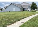 A well-maintained home with tidy landscaping features a two-car garage and a freshly mowed lawn at 1706 Creekwater Pass, Greenfield, IN 46140