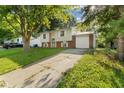 Classic split-level home featuring a one car garage and long driveway at 1809 Mutz Dr, Indianapolis, IN 46229